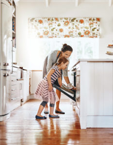 Shot of a little girl baking with her mother in the kitchen